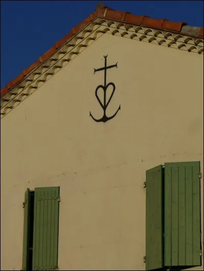 Cette croix récente (1926) comporte 3 symboles : les tridents, le cur et l'ancre. En quel honneur ?