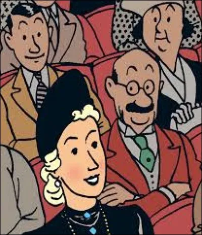 Madame Clairmont apprend l'agression de son mari alors qu'elle assiste à une représentation de magie dans un music-hall. C'est un personnage de l'album ...