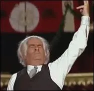 De quel instrument joue Mac Intosh dans la loge de Lefort pour faire croire  l'allemand qu'il s'agit d'une leon de musique ?