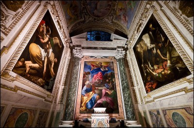 Deux des toiles les plus célèbres de Caravage ornent la Chapelle Cerasi de l'église Santa Maria del Popolo, à Rome, en flanquant un tableau réalisé par un peintre rival. Quel est le nom de ce rival ?