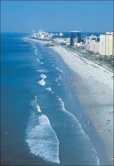 Comment s'appelle cette immense plage de sable blanc qui attire un nombre impressionnant de touristes  la station balnaire de Myrtle Beach ?
