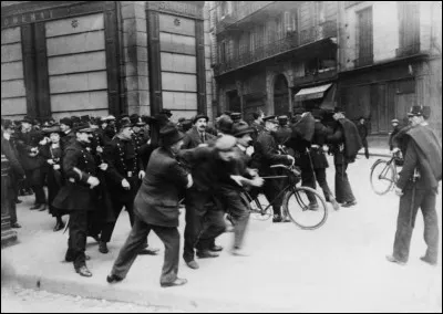 Photo prise le 1er mai 1920 : on y voit des manifestants qui affrontent la police lors de la fête du Travail. Voici ce que Wiki en dit : il y eut de violentes manifestations syndicales, la grève générale échoua à cause des syndicats "jaunes" et de la mobilisation de la bourgeoisie, les élèves des grandes écoles assurèrent le service des transports.''
C'était il y a cent ans mais où exactement ?