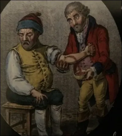 Pourquoi la personne habillée en rouge enlève-t-elle du sang à l'autre personne ?