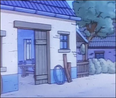 Lorsque Tintin arrive devant une maisonnette, qui voit-il en arrivant (à l'intérieur)  ?
