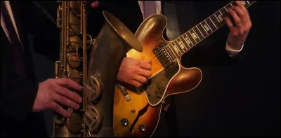 Qui joue de la guitare électrique dans l'album de Miles Davis "Bitches Brew" ?