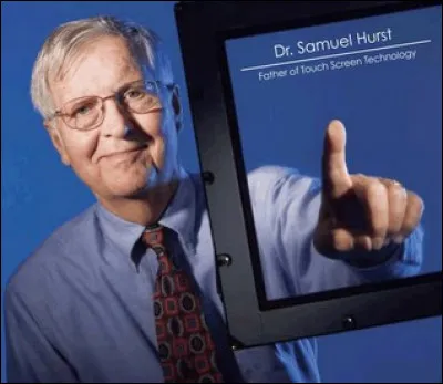 En quelle année Sam Hurst met-il au point le premier écran tactile aux États-Unis qui réagit à la pression d'un doigt ?