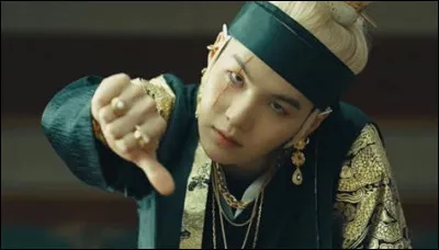 Avec quoi Suga tue-t-il le roi à la fin du clip ?