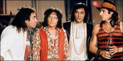 Dans quel film fait-il partie d'un groupe de rock baba cool sur le retour ?