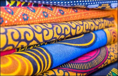 Le wax est un tissu imprimé de haute qualité aux couleurs chaudes, qui est typiquement :