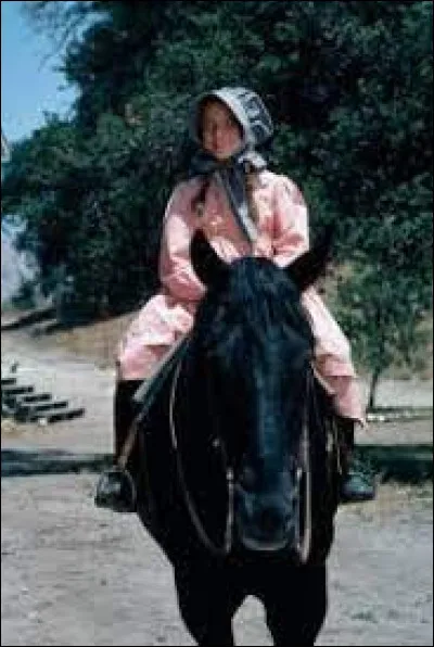 Qui achète le cheval de Laura pour l'offrir à son propre enfant ?