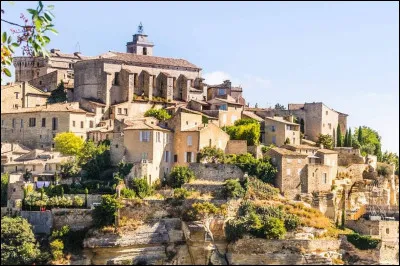 Parmi les plus beaux villages de France, quel est ce village perché surplombant la vallée, dont les maisons de pierres et l'abbaye sont accessibles par une route sinueuse, au cur des monts du Vaucluse, face au Luberon ?