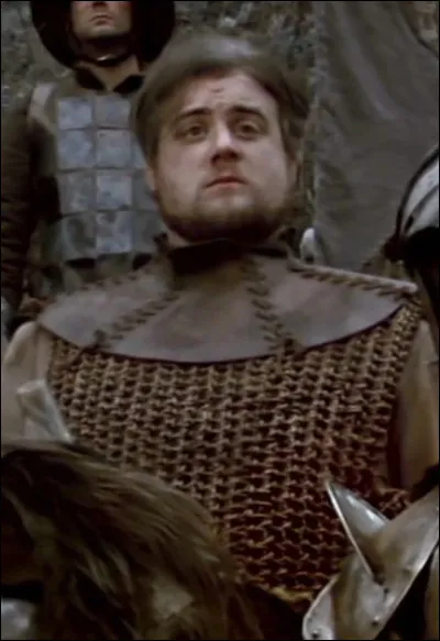 Comment s'appelle le sonneur de corne officiel de ''Kaamelott'', qui occupe également les fonctions de porte-drapeau ou d’écuyer ?