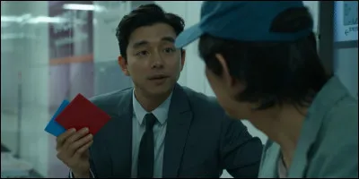 Comment s'appelle le jeu qui consiste à faire retourner un carton, utilisé pour entrer dans le jeu "Squid Game" ?