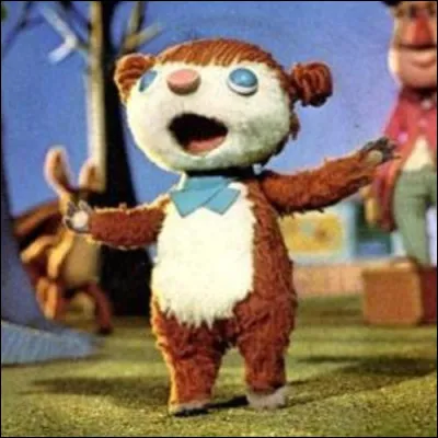 Quel est le nom de cet ourson de fiction dont le seul désir c'est de chanter ?