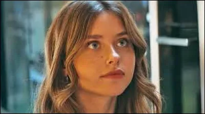 Sur la plage, que lit-elle lorsque Nick arrive avec ses amis ?