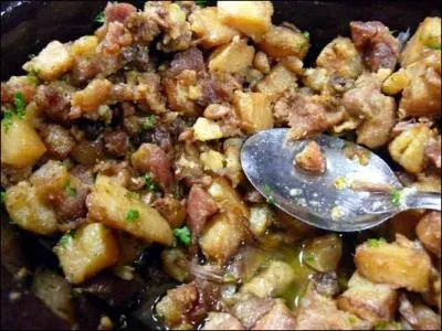 Quel est ce plat typique des anciens 'repas de cochon' dauphinois, fait avec des morceaux de gorge de porc, de l'ail, du persil et des pommes de terre ?