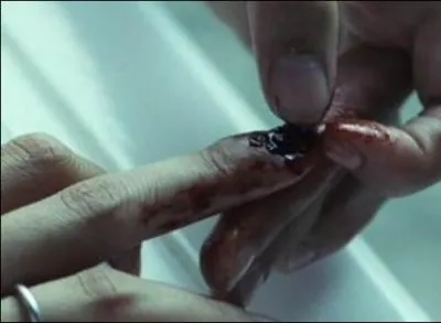 Pourquoi l'hrone se fait-elle enfermer dans la salle de bain en se faisant arracher son ongle ?