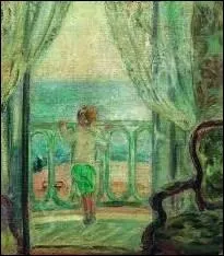 Jeune garon au balcon en bord de mer.