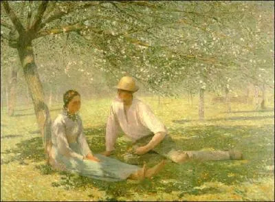 Jeune couple dans un verger au printemps.