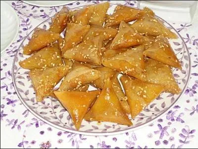 Feuilles de brik, 250 g d'amandes, 150 g de sucre en poudre, 1/2 cuillere  caf de cannelle, 2 cuilleres  soupe d'eau de fleur d'oranger, 1 noix de beurre, huile pour friture, 100 g de miel liquide, 1 jaune d'uf.