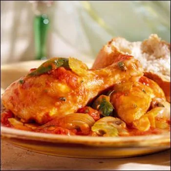 On nous sert un poulet préparé avec des champignons de Paris, du vin blanc, des échalotes, et des tomates :