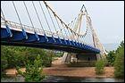 Ce pont routier suspendu de 270 mètres de long, traverse la Loire dans le département du même nom. Il a été construit en 2008 à :