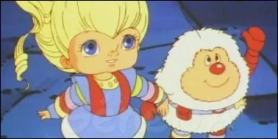 A cause de qui le pays de l'Arc en Ciel est en proie au désespoir dans "Blondine au pays de l'Arc en Ciel" ?