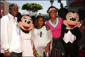 Qui est la personne en t-shirt rose qui pose avec Minnie et Mickey ?