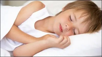 Le petit garçon _____ couché. (Complétez)