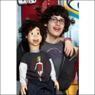 Qui se trimbale tout le temps avec une marionnette mal coiffée ?