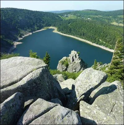 Partons sur les hauteurs du massif des Vosges. Ce lac se situe sur le ban de la commune d'Orbey en Alsace-Champagne-Ardenne-Lorraine. Une importante roche appelée Rocher Hans domine le lac, elle-même coiffée d'une statue de la Vierge.