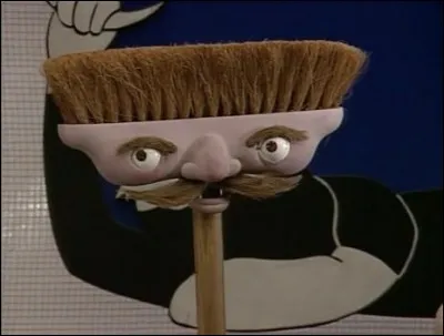 Comment s'appelle le concierge et archiviste de la série "Téléchat" ?